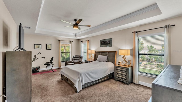 bedroom featuring a raised ceiling, light carpet, and ornamental molding