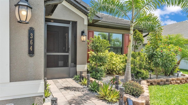 entrance to property with stucco siding