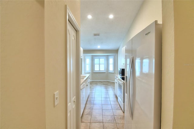 3430 Hilson Dr, Lakeland, FL 33812 - hallway featuring baseboards, visible vents, recessed lighting, and light tile patterned flooring