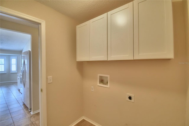 3430 Hilson Dr, Lakeland, FL 33812 - washroom with hookup for an electric dryer, light tile patterned flooring, baseboards, hookup for a washing machine, and cabinet space