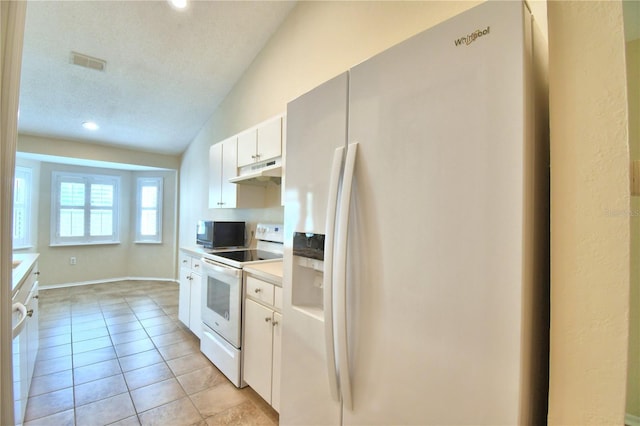 3430 Hilson Dr, Lakeland, FL 33812 - kitchen with white appliances, light countertops, white cabinets, under cabinet range hood, and visible vents