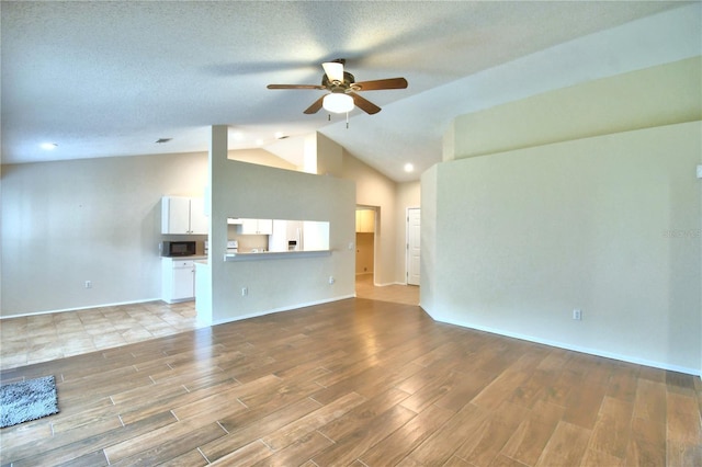 3430 Hilson Dr, Lakeland, FL 33812 - unfurnished living room featuring baseboards, high vaulted ceiling, light wood-style floors, and ceiling fan
