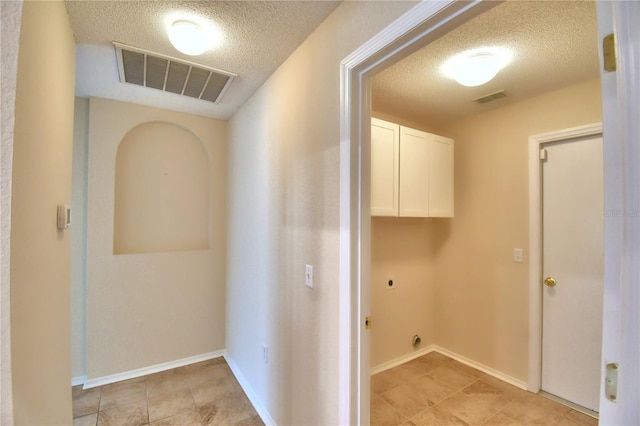 3430 Hilson Dr, Lakeland, FL 33812 - laundry room featuring cabinet space, a textured ceiling, visible vents, and electric dryer hookup