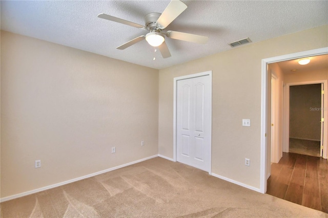 3430 Hilson Dr, Lakeland, FL 33812 - unfurnished bedroom featuring visible vents, a closet, baseboards, a textured ceiling, and carpet flooring