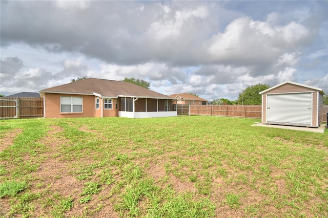 3430 Hilson Dr, Lakeland, FL 33812 - view of yard with a fenced backyard, an outdoor structure, a sunroom, and a storage unit