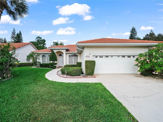 530 Greenway Dr, Lake Wales, FL 33898 - mediterranean / spanish-style house with an attached garage, stucco siding, a front yard, concrete driveway, and a tiled roof