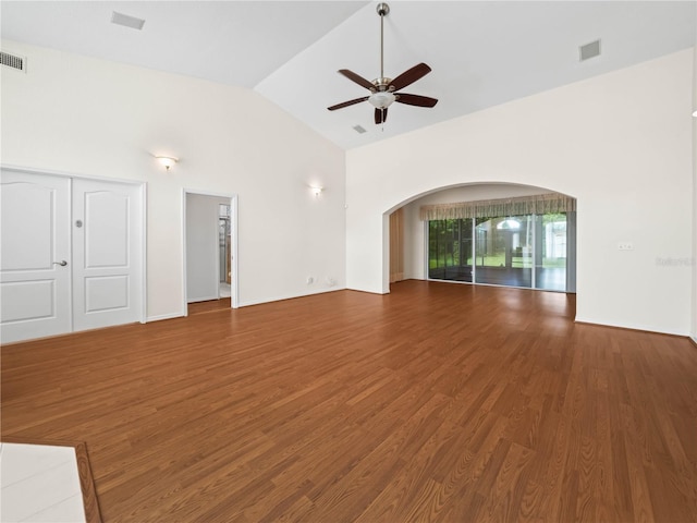 530 Greenway Dr, Lake Wales, FL 33898 - unfurnished living room featuring arched walkways, a ceiling fan, wood finished floors, lofted ceiling, and visible vents