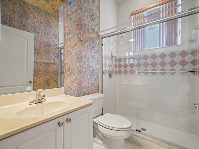 530 Greenway Dr, Lake Wales, FL 33898 - bathroom with vanity, a stall shower, wallpapered walls, and toilet