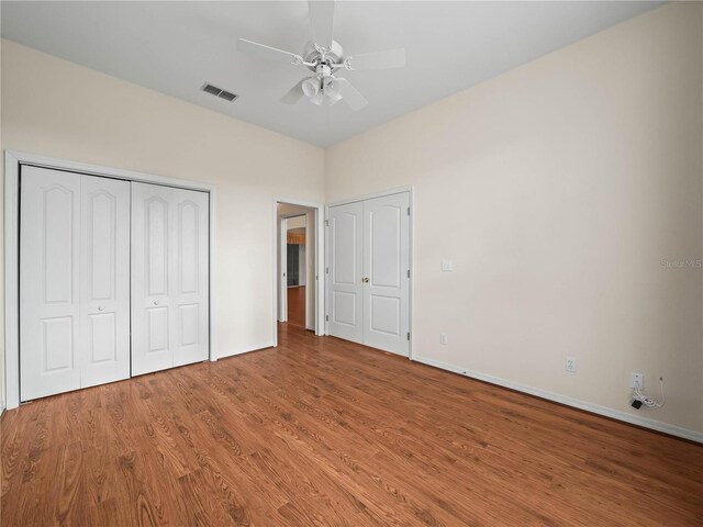 530 Greenway Dr, Lake Wales, FL 33898 - unfurnished bedroom featuring visible vents, baseboards, wood finished floors, and two closets