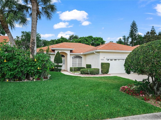 530 Greenway Dr, Lake Wales, FL 33898 - mediterranean / spanish home featuring a front yard, stucco siding, a tiled roof, an attached garage, and driveway