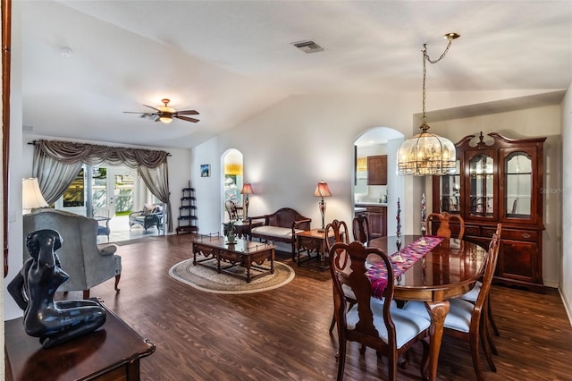 284 Lake Suzanne Dr, Lake Wales, FL 33859 - dining space featuring dark wood-style floors, vaulted ceiling, visible vents, arched walkways, and ceiling fan with notable chandelier