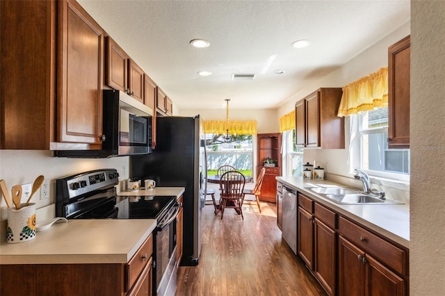 284 Lake Suzanne Dr, Lake Wales, FL 33859 - kitchen featuring a sink, a wealth of natural light, appliances with stainless steel finishes, dark wood-style flooring, and visible vents