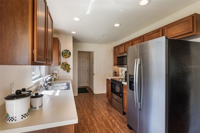 284 Lake Suzanne Dr, Lake Wales, FL 33859 - kitchen with dark wood finished floors, brown cabinets, stainless steel appliances, and a sink