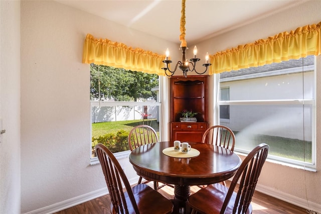 284 Lake Suzanne Dr, Lake Wales, FL 33859 - dining space featuring wood finished floors, baseboards, and a notable chandelier
