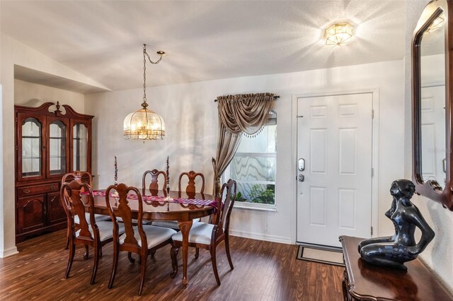 284 Lake Suzanne Dr, Lake Wales, FL 33859 - dining area with dark wood finished floors, baseboards, and a chandelier