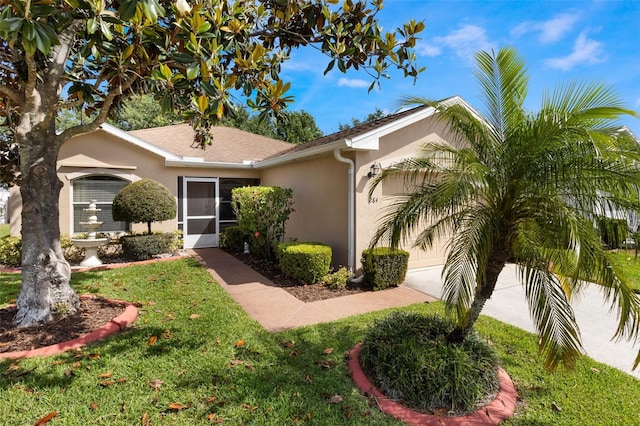 284 Lake Suzanne Dr, Lake Wales, FL 33859 - view of front of house featuring stucco siding, an attached garage, decorative driveway, and a front lawn