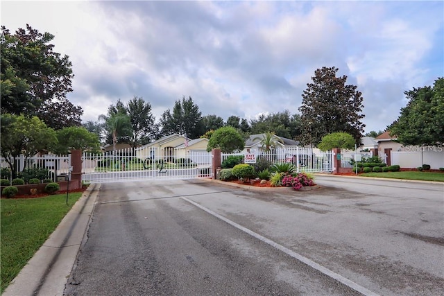 284 Lake Suzanne Dr, Lake Wales, FL 33859 - view of street featuring a gate, a residential view, a gated entry, and curbs