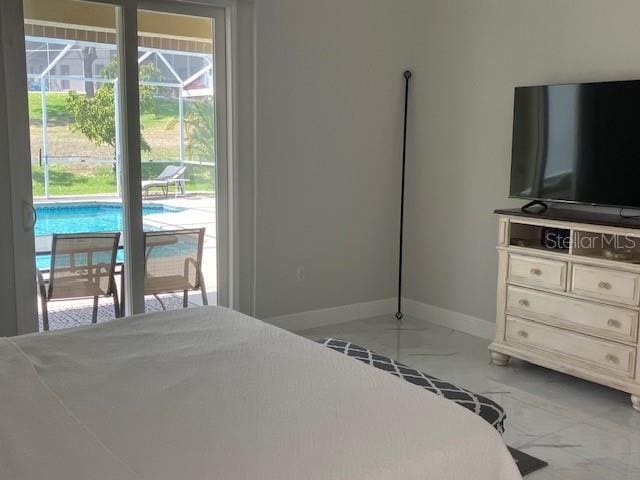 1681 Waterview Loop, Haines City, FL 33844 - bedroom featuring access to exterior, light marble finish flooring, and baseboards