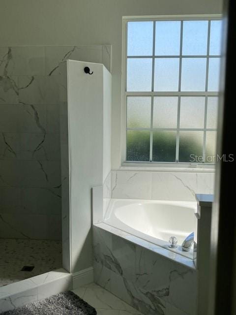 1681 Waterview Loop, Haines City, FL 33844 - full bath featuring a marble finish shower, marble finish floors, a garden tub, and baseboards
