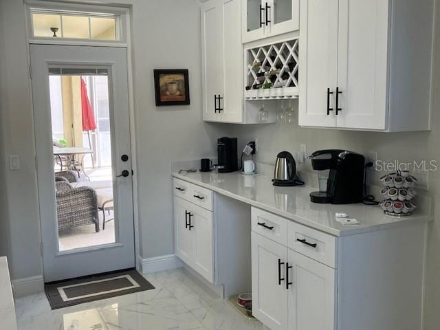 1681 Waterview Loop, Haines City, FL 33844 - kitchen with light marble finish floors, white cabinetry, and light countertops