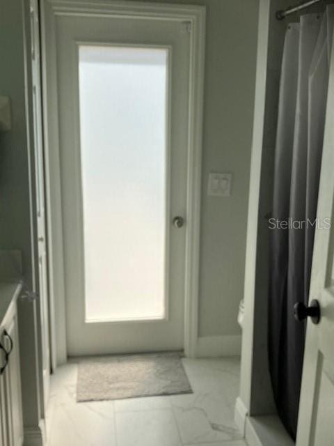 1681 Waterview Loop, Haines City, FL 33844 - bathroom with curtained shower, marble look tiles, baseboards, and vanity