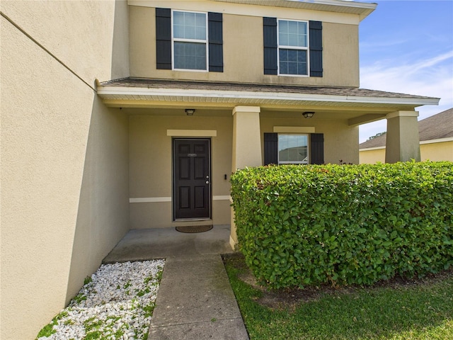property entrance featuring stucco siding
