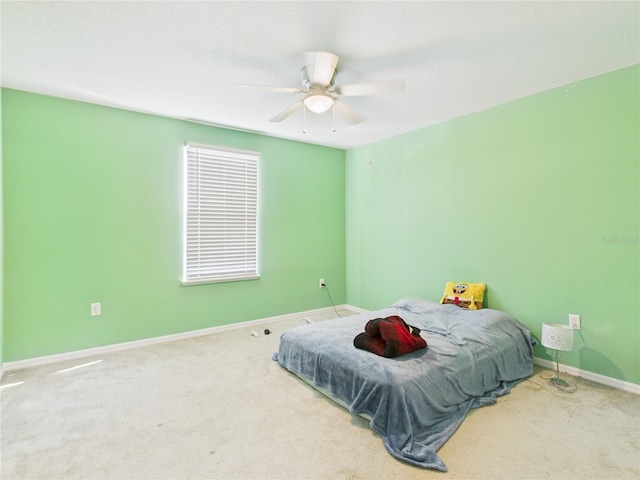 bedroom featuring baseboards, a ceiling fan, and carpet flooring