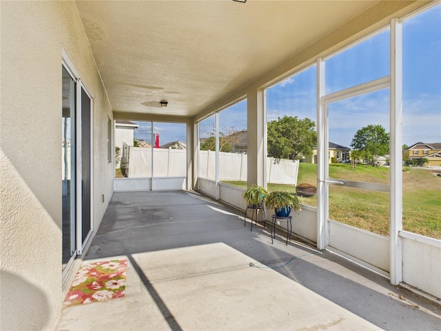 unfurnished sunroom featuring a residential view