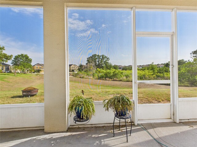 unfurnished sunroom with an outdoor fire pit