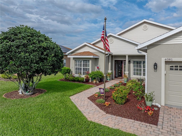 4081 Dunmore Dr, Lake Wales, FL 33859 - view of front of house with stucco siding, a front lawn, and an attached garage