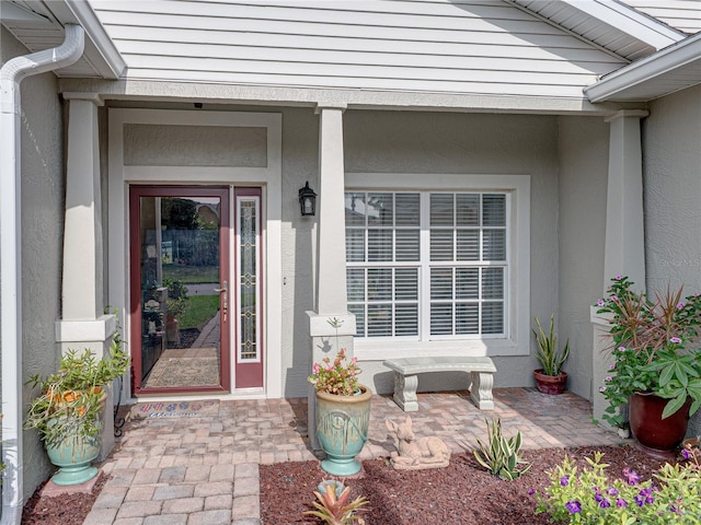 4081 Dunmore Dr, Lake Wales, FL 33859 - view of exterior entry with stucco siding and covered porch