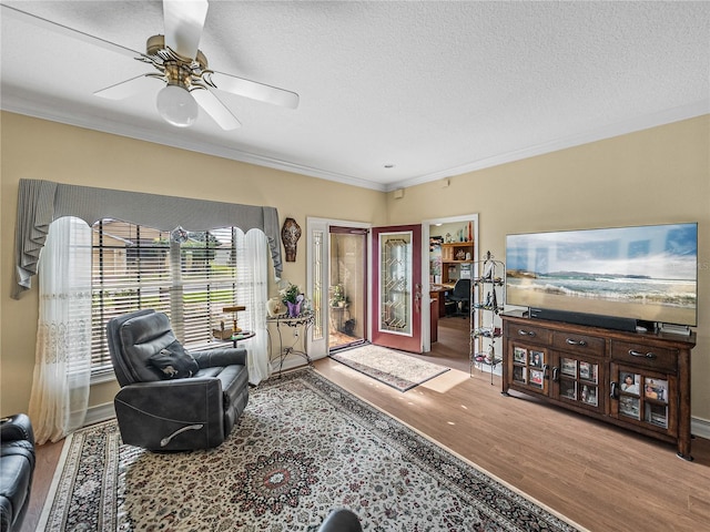 4081 Dunmore Dr, Lake Wales, FL 33859 - living room featuring ornamental molding, wood finished floors, ceiling fan, and a textured ceiling