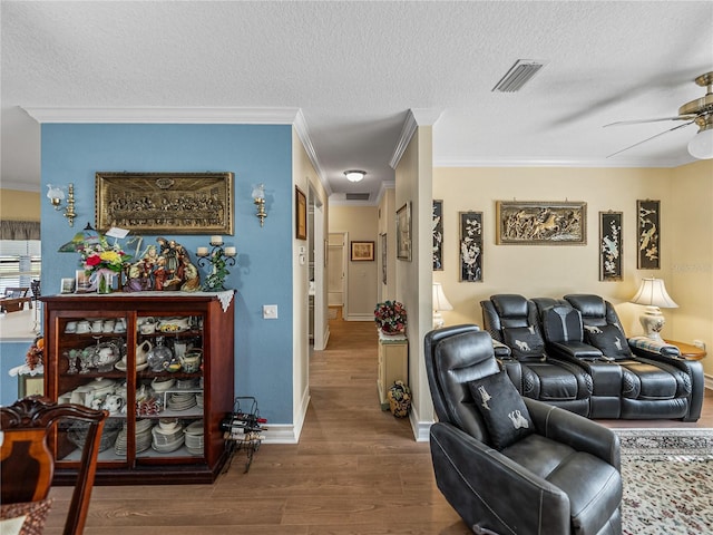 4081 Dunmore Dr, Lake Wales, FL 33859 - living area with wood finished floors, ornamental molding, a textured ceiling, ceiling fan, and baseboards
