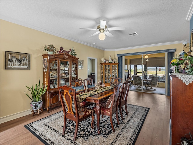 4081 Dunmore Dr, Lake Wales, FL 33859 - dining space featuring ceiling fan, wood finished floors, crown molding, a textured ceiling, and baseboards