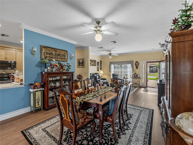 4081 Dunmore Dr, Lake Wales, FL 33859 - dining room with a ceiling fan, wood finished floors, ornamental molding, a textured ceiling, and baseboards