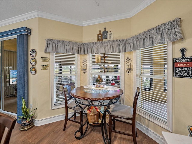 4081 Dunmore Dr, Lake Wales, FL 33859 - dining space with baseboards, wood finished floors, and crown molding