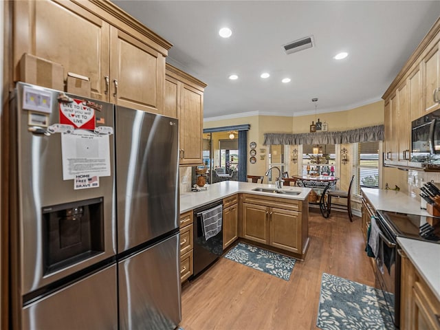 4081 Dunmore Dr, Lake Wales, FL 33859 - kitchen with black appliances, a sink, crown molding, a peninsula, and light countertops