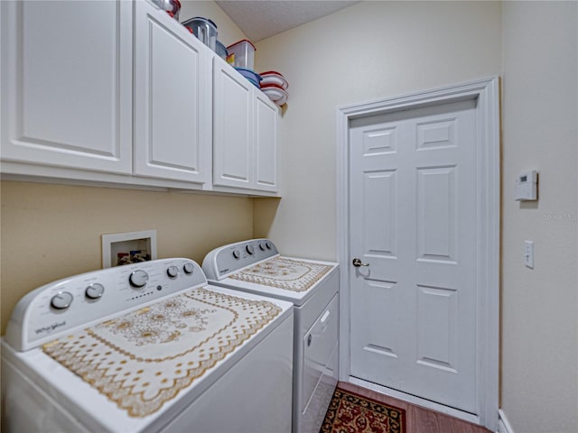 4081 Dunmore Dr, Lake Wales, FL 33859 - laundry area with washing machine and clothes dryer, cabinet space, wood finished floors, and baseboards