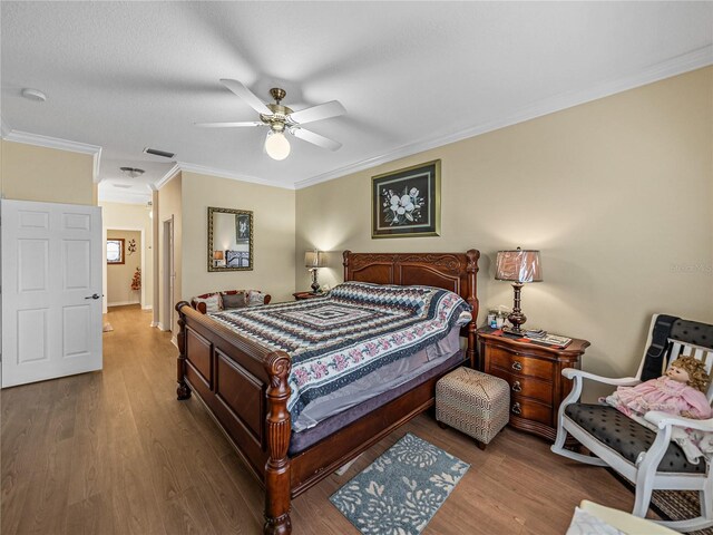 4081 Dunmore Dr, Lake Wales, FL 33859 - bedroom with wood finished floors, crown molding, a ceiling fan, and baseboards