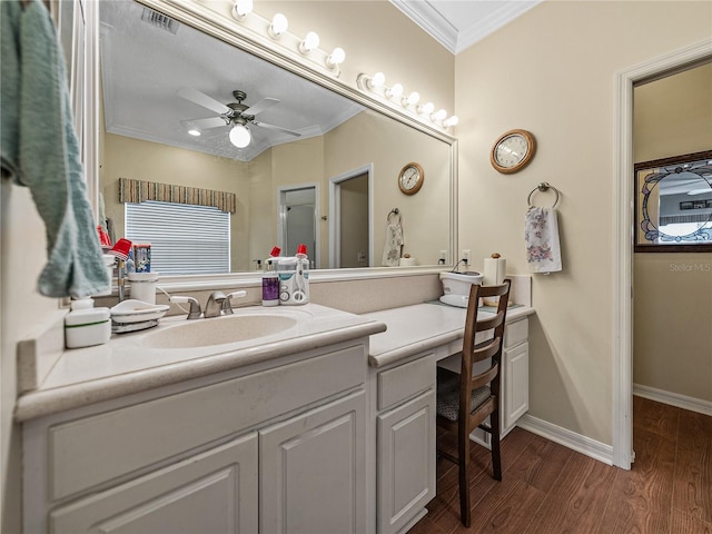 4081 Dunmore Dr, Lake Wales, FL 33859 - bathroom featuring crown molding, vanity, wood finished floors, ceiling fan, and baseboards