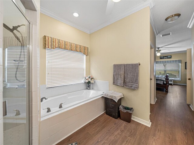 4081 Dunmore Dr, Lake Wales, FL 33859 - full bathroom featuring a ceiling fan, ornamental molding, a bath, a stall shower, and wood finished floors