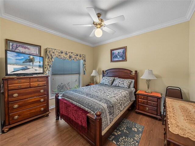 4081 Dunmore Dr, Lake Wales, FL 33859 - bedroom with dark wood-type flooring, ornamental molding, and ceiling fan
