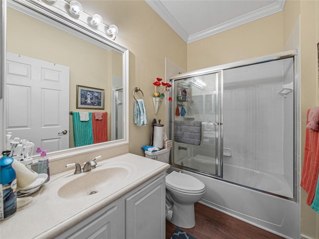 4081 Dunmore Dr, Lake Wales, FL 33859 - bathroom with crown molding, vanity, toilet, bath / shower combo with glass door, and wood finished floors