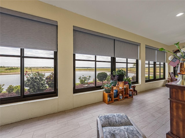 4081 Dunmore Dr, Lake Wales, FL 33859 - sunroom with a water view, wood tiled floors, and recessed lighting
