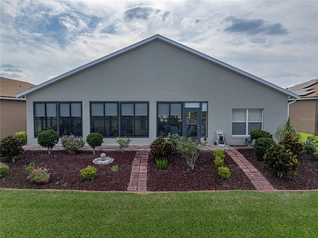 4081 Dunmore Dr, Lake Wales, FL 33859 - rear view of property with stucco siding and a yard