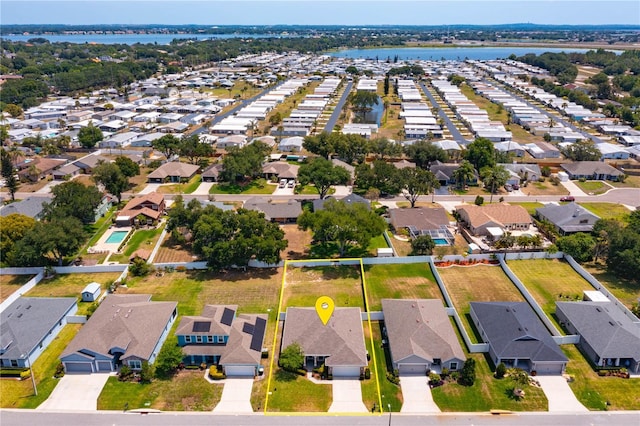 birds eye view of property with a residential view and a water view