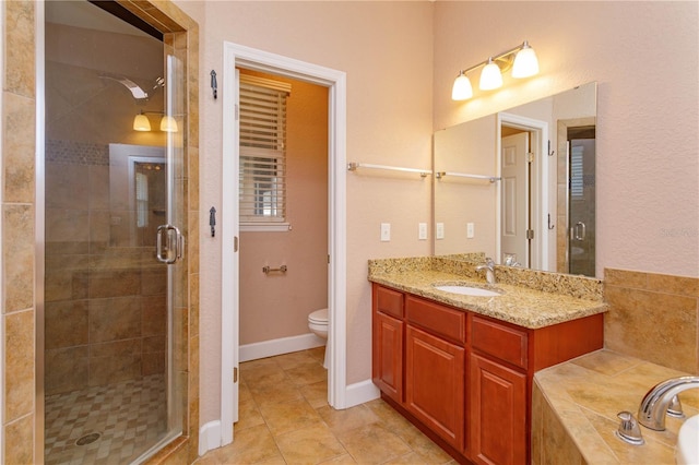 full bath with toilet, vanity, tile patterned floors, and a stall shower