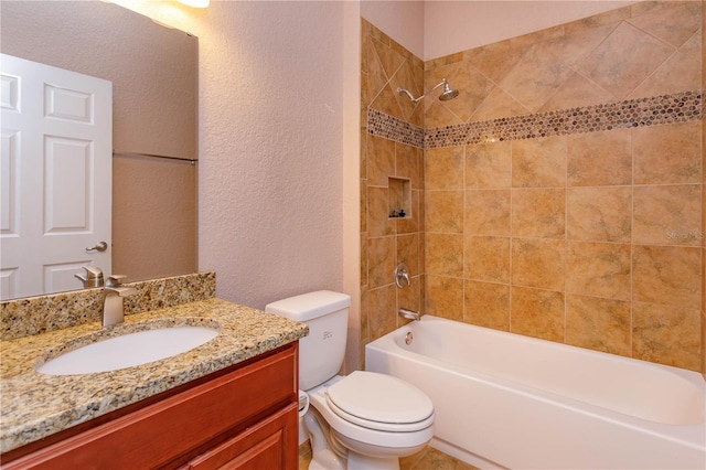 bathroom with a textured wall, toilet, vanity, and  shower combination