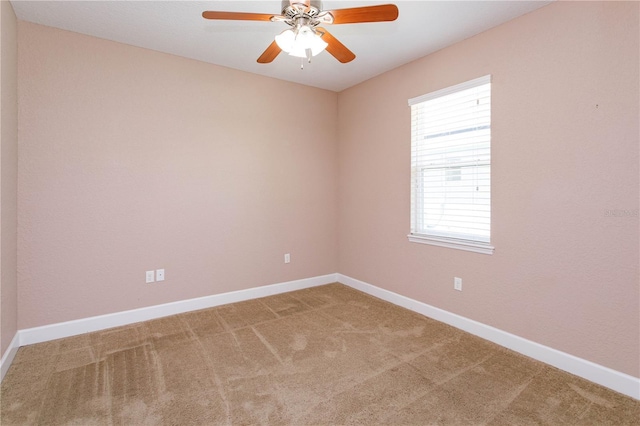 unfurnished room with carpet and baseboards