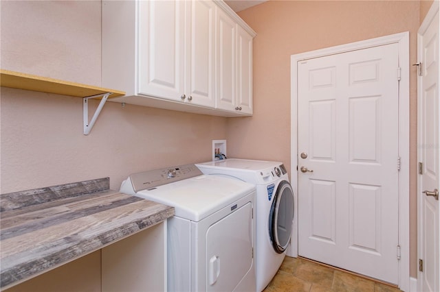 clothes washing area with washer and clothes dryer and cabinet space